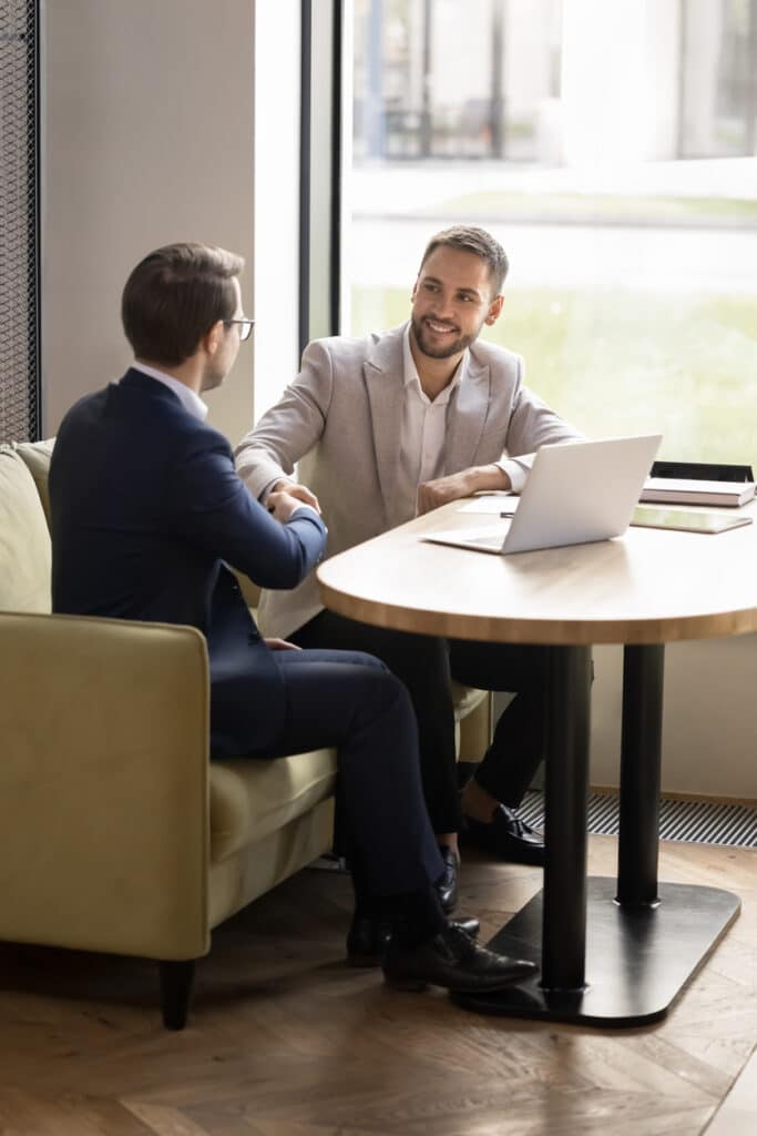 happy business partners men giving handshakes with respect